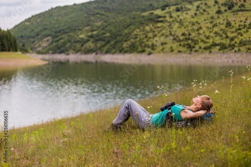 Woman hiker enjoys resting in the beautiful nature.