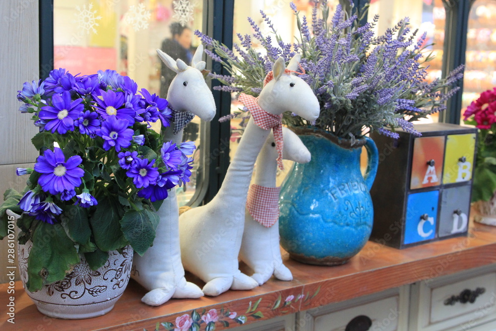 giraffes and flowers decoration on a wooden background