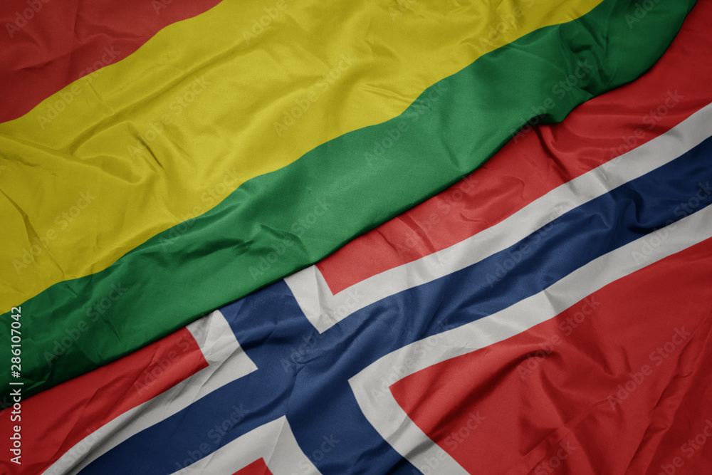 waving colorful flag of norway and national flag of bolivia.