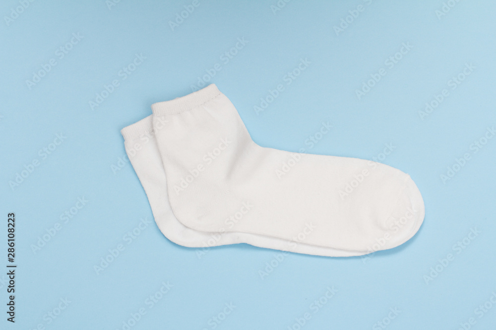 Pair of white women socks on blue background. Pair of white women socks on blue background.