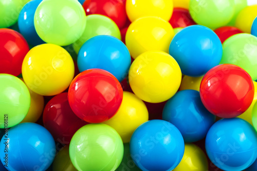 Colored plastic balls in pool of game room. Dry Swimming pool for fun and jumping in colored plastic balls. The concept of celebration and fun
