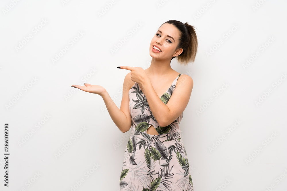Young woman over isolated white background holding copyspace imaginary on the palm to insert an ad Young woman over isolated white background holding copyspace imaginary on the palm to insert an ad