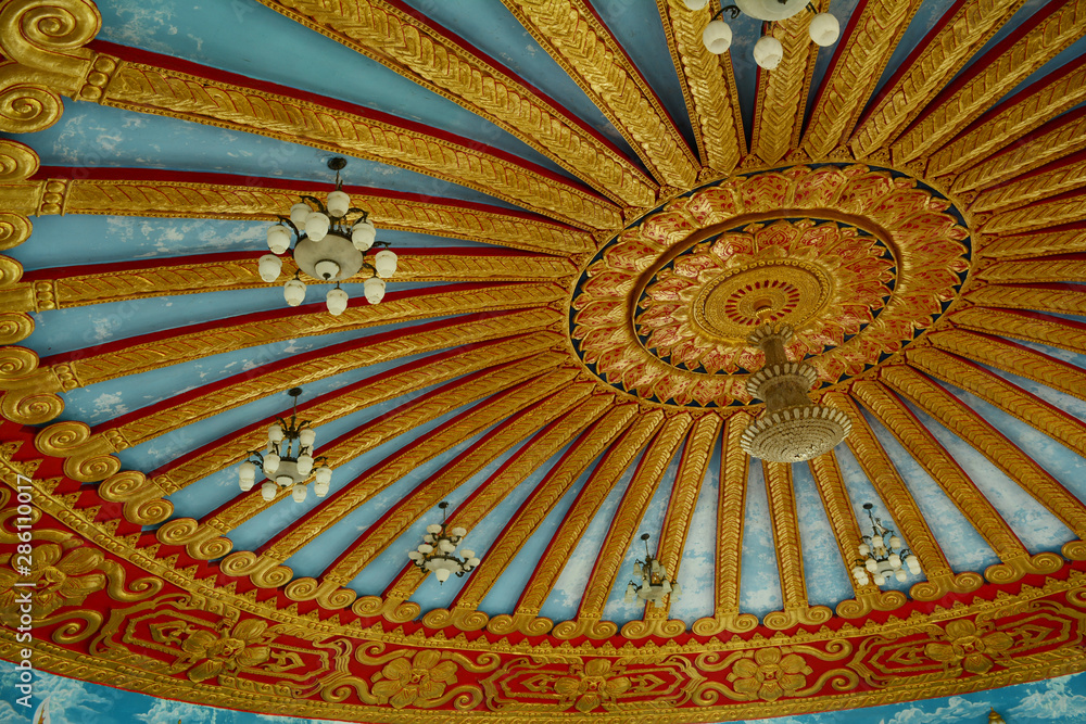 the pattern of traditional carve on ceiling of the church in temple in Thailand