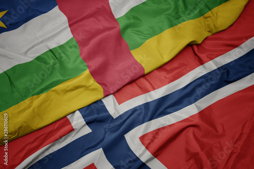waving colorful flag of norway and national flag of central african republic.