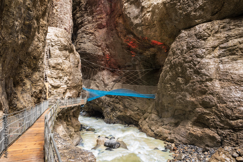 Glacier gorge with the river Weisse Lutschine and the climbing net Spiderweb in Grindelwald photo