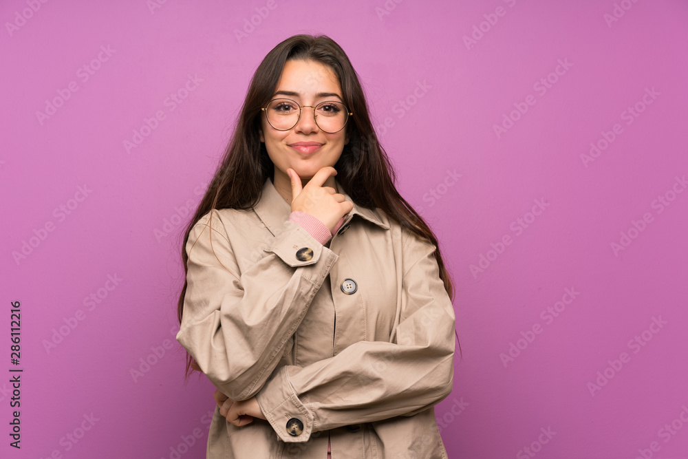 Teenager girl over purple wall laughing Teenager girl over purple wall laughing
