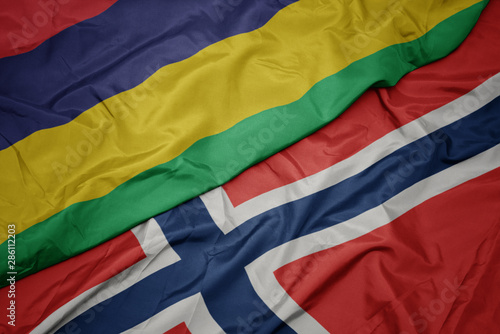 waving colorful flag of norway and national flag of mauritius.