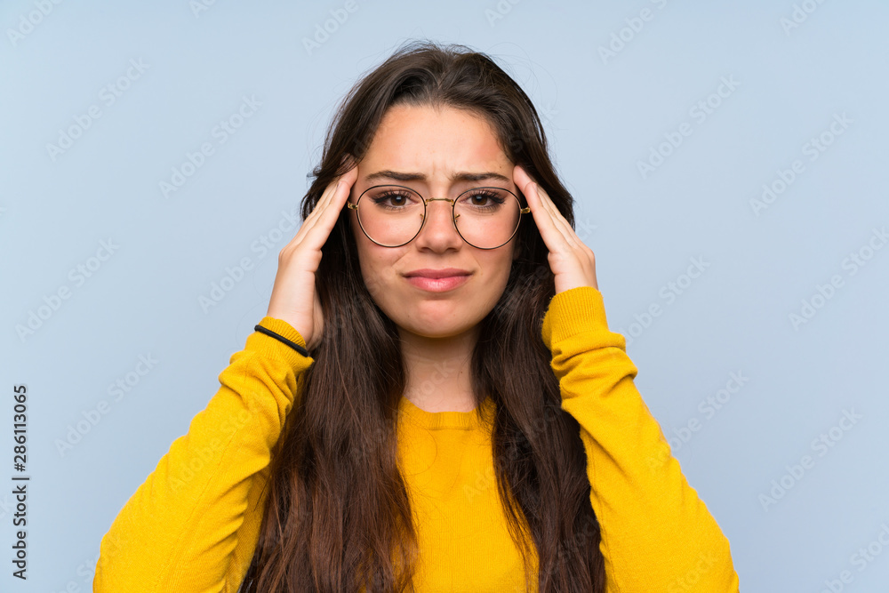 Teenager girl over isolated blue wall unhappy and frustrated with something. Negative facial expression Teenager girl over isolated blue wall unhappy and frustrated with something. Negative facial expression