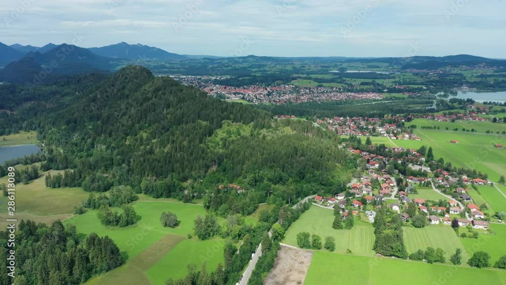 Aerial view of landscape around Neuschwanstein Castle, lush green hills of Bavarian Alps mountains in summer - panorama of Bavaria from above, Germany, Europe Aerial view of landscape around Neuschwanstein Castle, lush green hills of Bavarian Alps mountains in summer - panorama of Bavaria from above, Germany, Europe