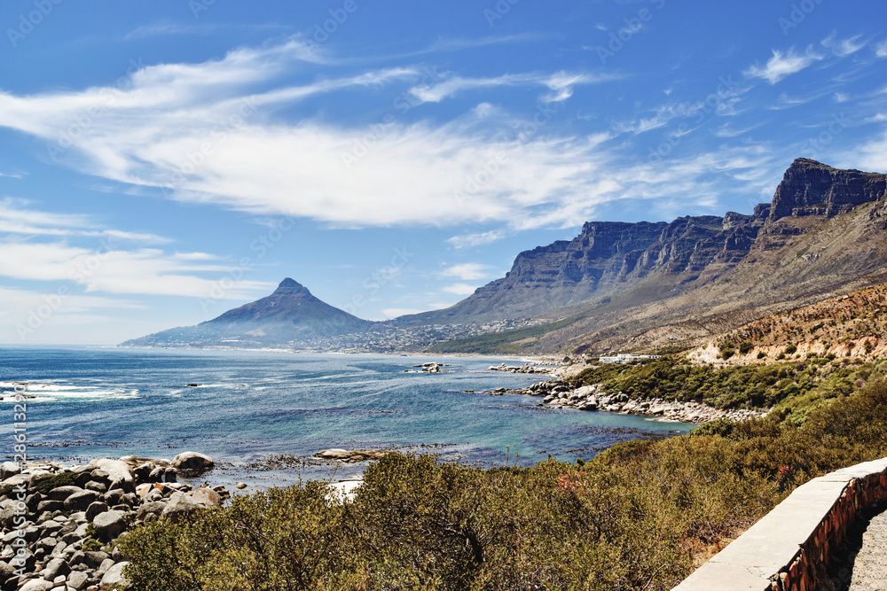 Camps Bay and Twelve Apostles against blue ocean and sky on sunny day, seen from Oudekraal