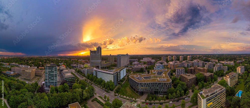 Obraz premium Munich from above, a panoramic droneshot in the colorful evening at sunset.