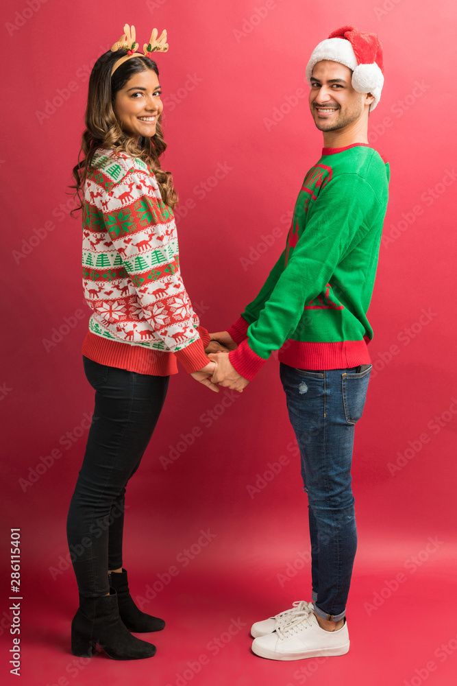 Attractive Man And Woman Standing Against Red Background Attractive Man And Woman Standing Against Red Background