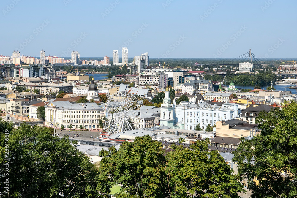 View of the old Podil district of the city of Kyiv and Dnipro River Dnieper with various bridges. Ukraine, August 2019
