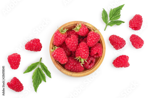 raspberries in wooden bowl with leaves isolated on white background. Top view. Flat lay