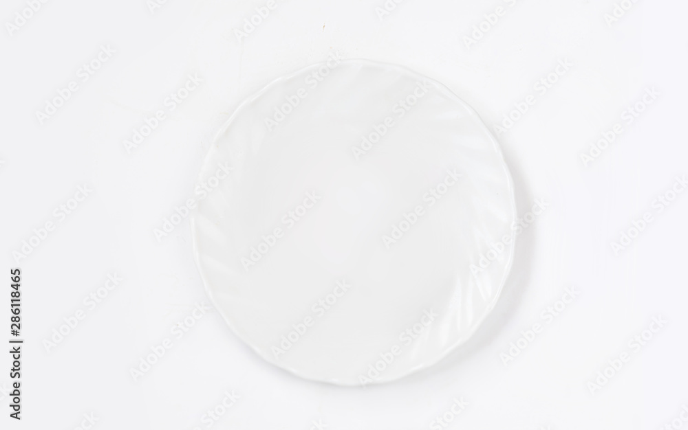 White plate on white background top view. Flat lay. White plate on white background top view. Flat lay.