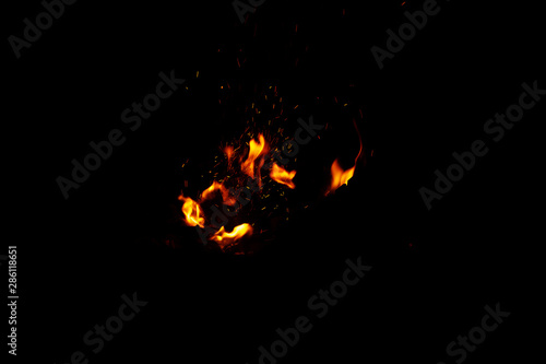 High resolution photo of flame and sparkl on black background. fire flames. Background Texture. Elemen for design abstract of movement of fire flames © ismishko