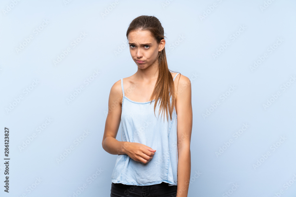 Young woman over isolated blue background with sad and depressed expression Young woman over isolated blue background with sad and depressed expression