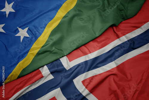 waving colorful flag of norway and national flag of Solomon Islands , .
