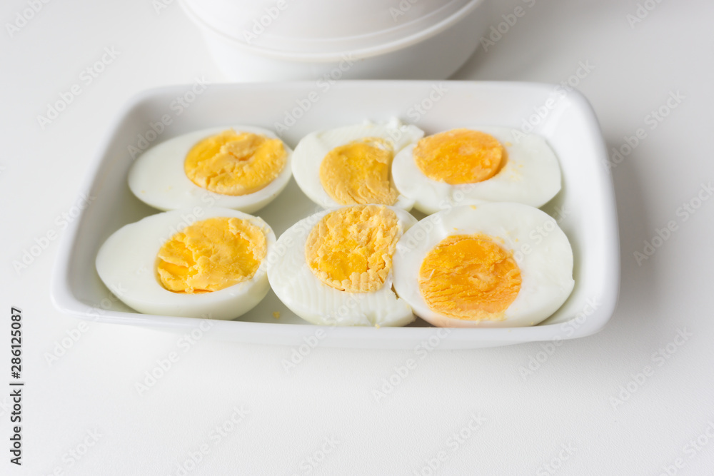 Sliced boiled eggs on white plate, Ready to eat. Sliced boiled eggs on white plate, Ready to eat.