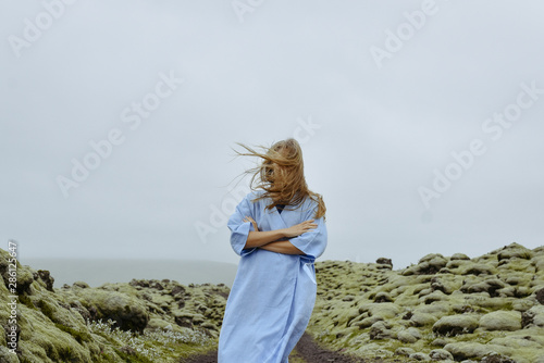 Young beautiful woman in an old moss-covered lava field  volcanic area in Iceland. Amazing nature