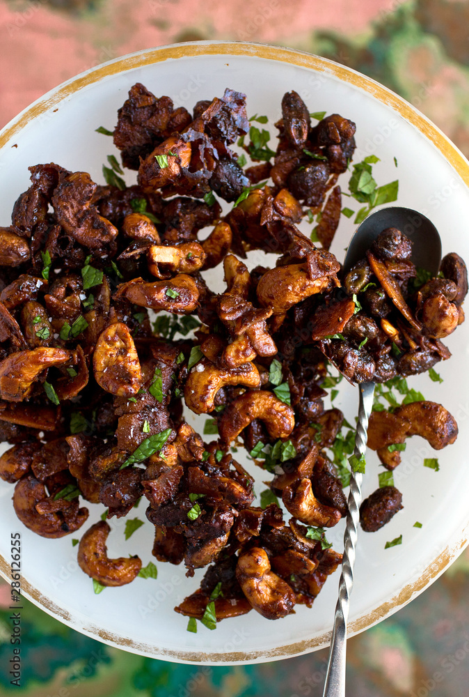 Overhead view of tamarind spiced mixed nuts on cake stand Overhead view of tamarind spiced mixed nuts on cake stand