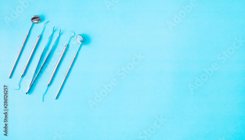 Dental tools use for dentist on the blue background  flat lay  top view.