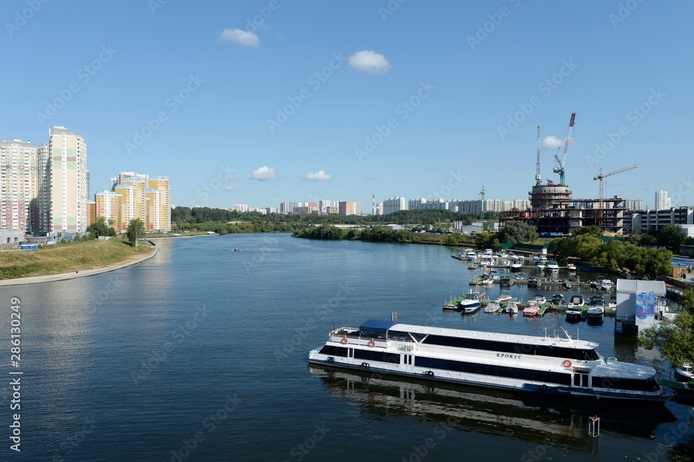 Boats and yachts at the pier of the yacht club Shore House in Myakininskaya floodplain on the banks of the Moscow river near 