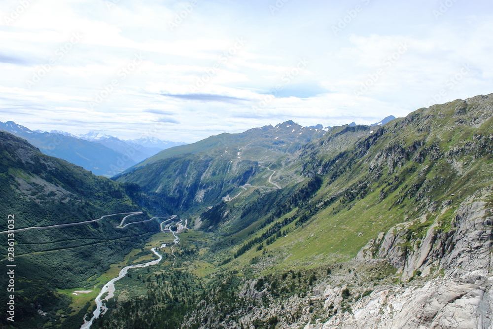 Panoramic view in Swiss Alps. Winding road to top of mountain. Euro-trip. Outdoor. Selective focus