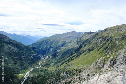 Panoramic view in Swiss Alps. Winding road to top of mountain. Euro-trip. Outdoor. Selective focus