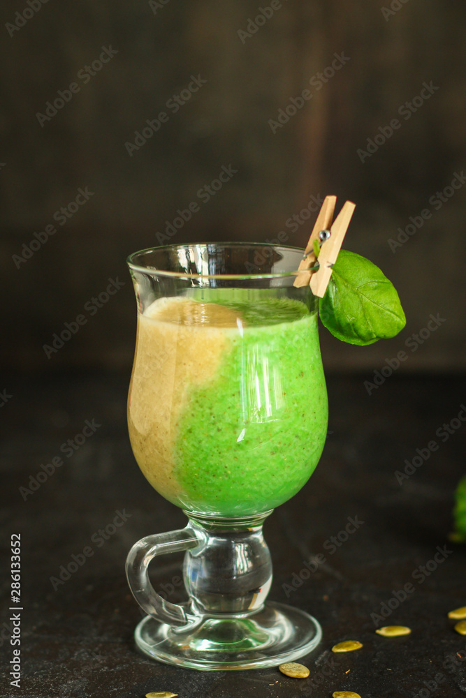 Fototapeta premium green smoothie (avocado, banana, spinach and other ingredients) menu. top food background. copy space
