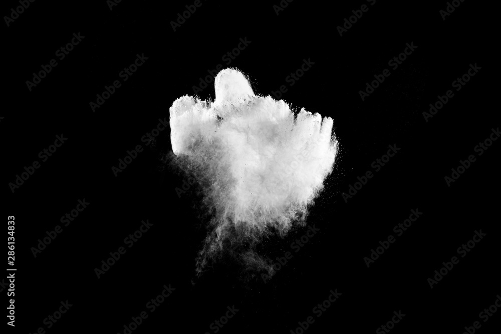 White powder explosion cloud against black background.White dust particles splash. White powder explosion cloud against black background.White dust particles splash.