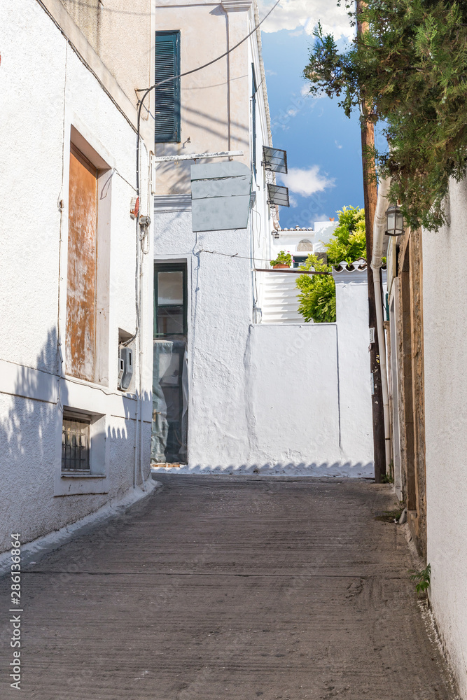Walking on traditioanal greek streets with white house, Spetses Saronic gulf, Greece