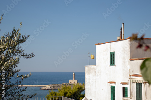 white lighthouse in the blue sea view