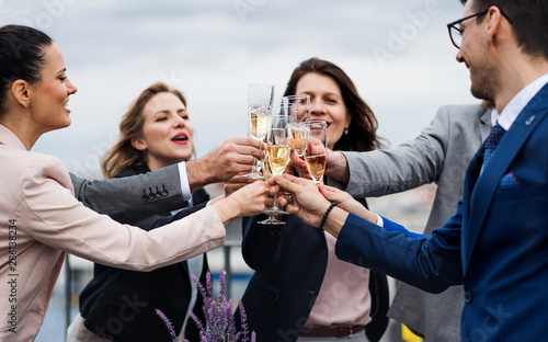 Sticker A group of joyful businesspeople having a party outdoors on roof terrace in city