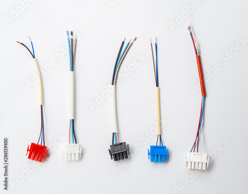 Top view few colorful wire connectors and wires on a white background