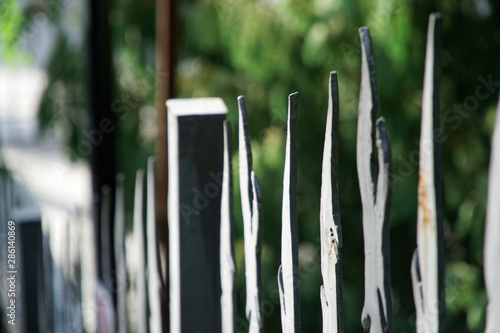 Weathered metal post finials Trident metal fence for protection against chimeras and evil power. photo