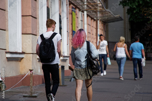 Kyiv, Ukraine, July 6, 2019: Young pretty hipster woman having fun hipster clothes, pink hair, walking on street