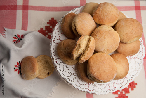 Homemade baking. Butter buns on a vintage linen tablecloth.