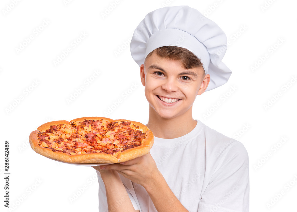 Happy handsome teen boy in chef hat holding cooked appetizing pizza. Guy holds plate with fresh pizza in his hands, isolated on white background. Portrait of cute child showing delicious Italian pizza Happy handsome teen boy in chef hat holding cooked appetizing pizza. Guy holds plate with fresh pizza in his hands, isolated on white background. Portrait of cute child showing delicious Italian pizza