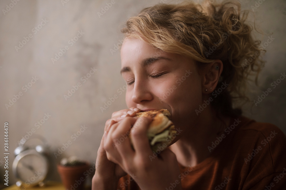 Portrait of young woman eating Hamburger Portrait of young woman eating Hamburger