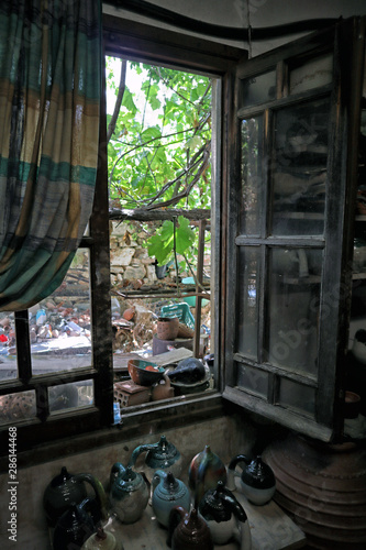 Potter's studio window with colourful ceramic ware, Damalas, Naxos, Greek Islands