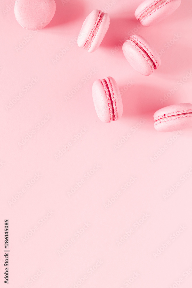 Pink macaroons on pink background. Sweet background. Flat lay, top view, copy space