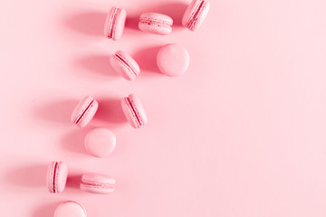 Pink macaroons on pink background. Sweet background. Flat lay, top view, copy space
