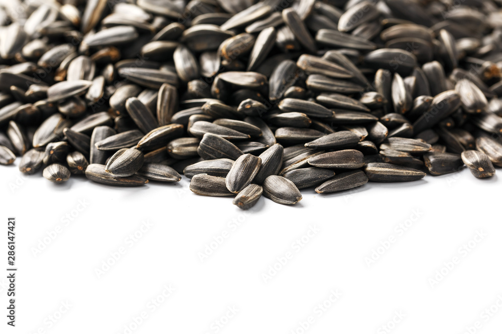 Seeds in a black shell are a bunch on a white background. In full screen Seeds in a black shell are a bunch on a white background. In full screen