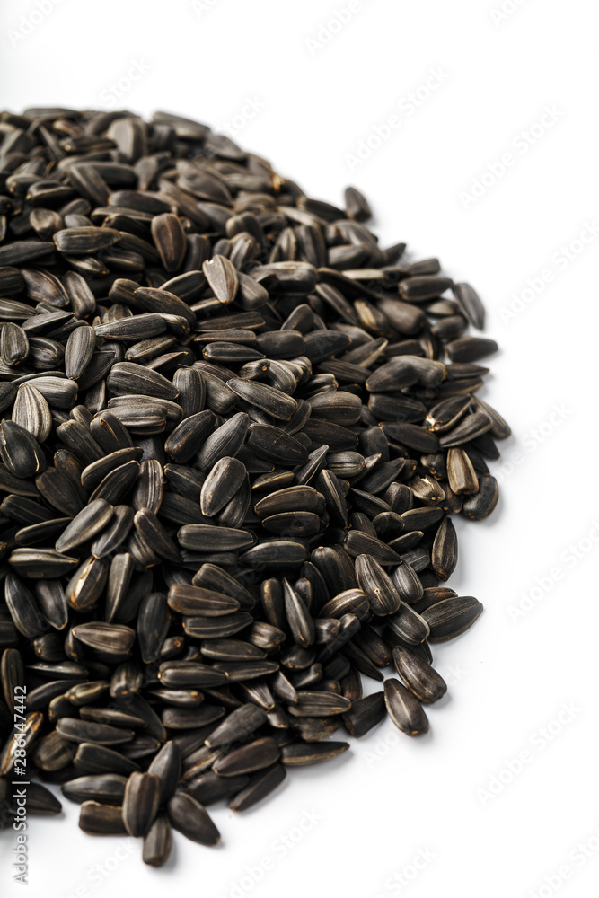 Seeds in a black shell are a bunch on a white background. In full screen Seeds in a black shell are a bunch on a white background. In full screen