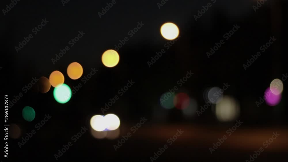 Lights of the night city background. Defocus headlights of moving cars urban traffic. Abstract bright blured colored bokeh. Lights of the night city background. Defocus headlights of moving cars urban traffic. Abstract bright blured colored bokeh.