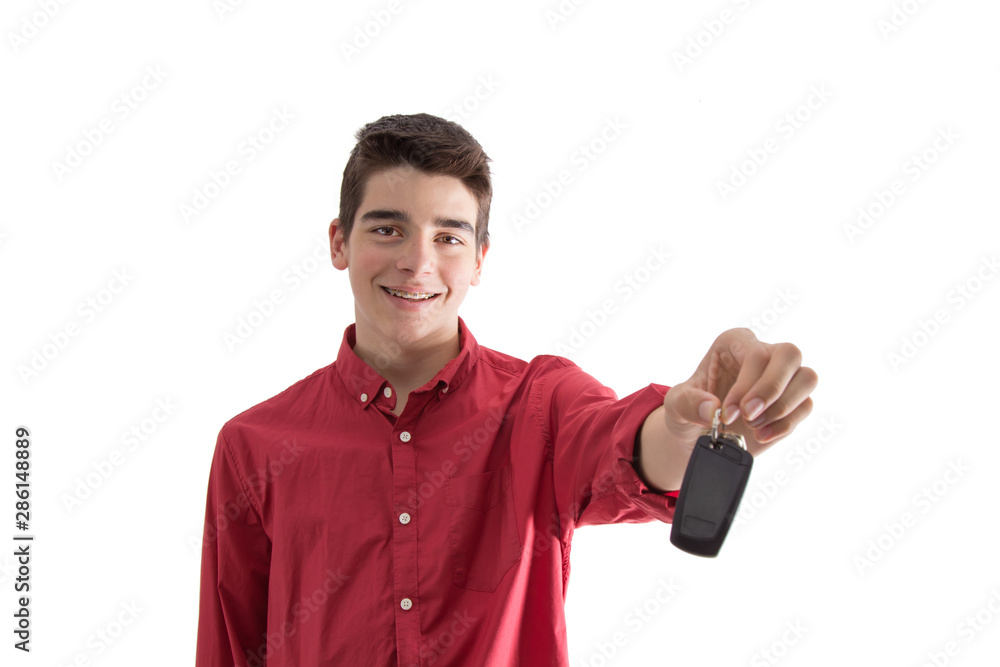 young man smiling isolated with car keys or remote control young man smiling isolated with car keys or remote control