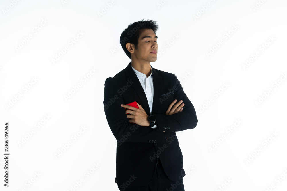 Handsome young businessman Asian caucasian wear a black suit with black hair, be a smile and standing smart poses. Hold and use a smartphone. On white background. Handsome young businessman Asian caucasian wear a black suit with black hair, be a smile and standing smart poses. Hold and use a smartphone. On white background.