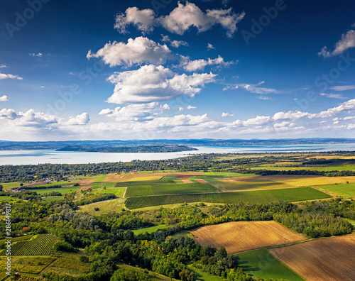 Aerial view of agricultural fields with lake Balaton