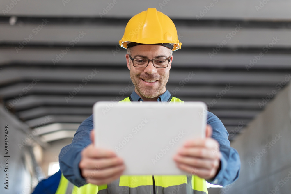 Architect using laptop at construction site Architect using laptop at construction site